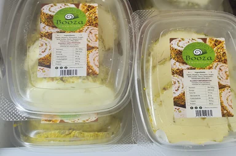Booza Levantina tubs held in a retail freezer cabinet.
